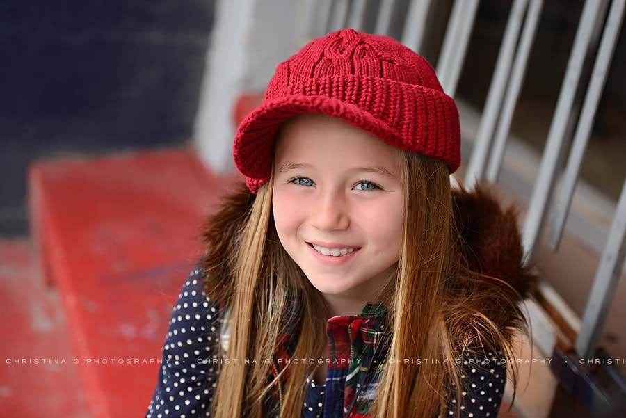 YOUNG GIRL WITH RED HAT SMILING