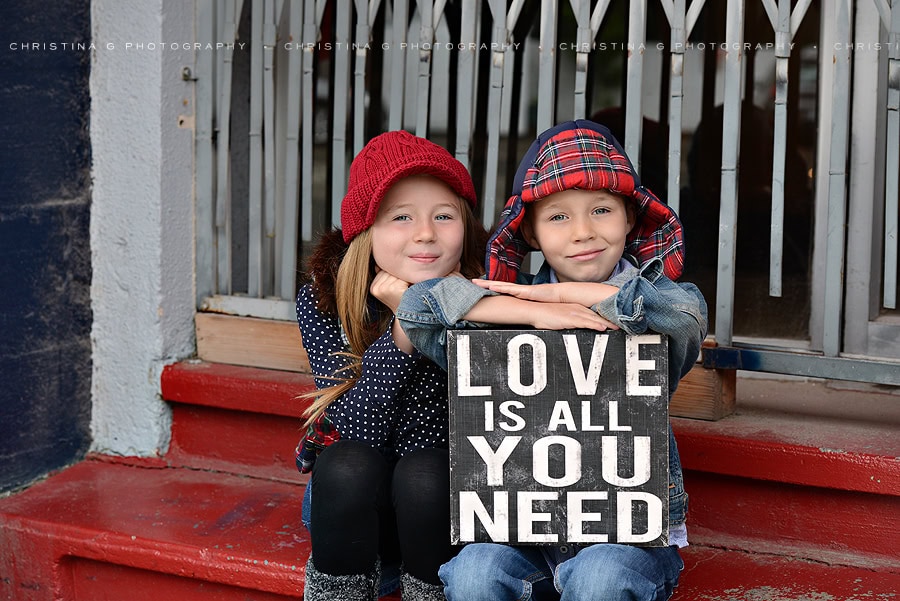 GIRL & BOY WITH HAT SITTING ON STEPS IN MIDTOWN COEUR D'ALENE