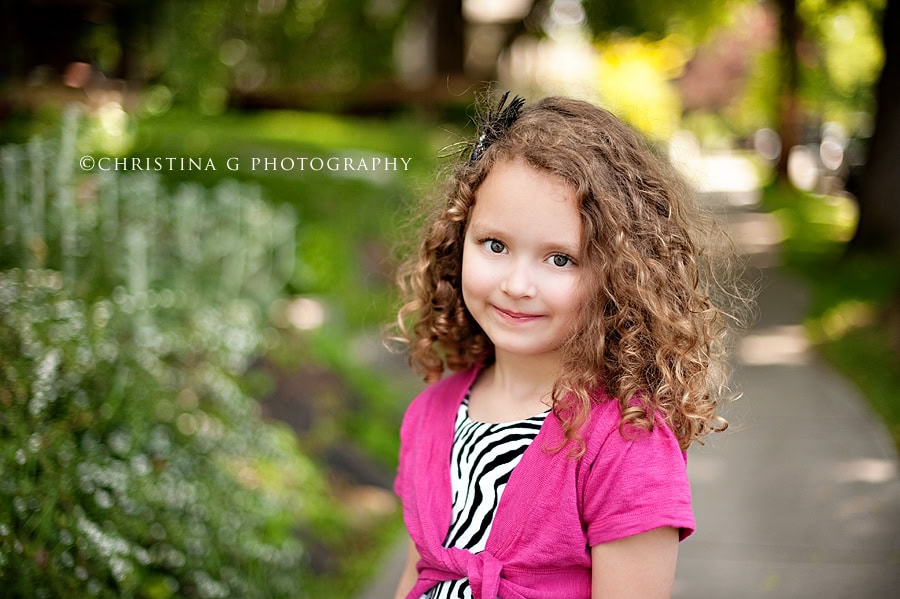 LITTLE GIRL WITH PINK SWEATER SMILING