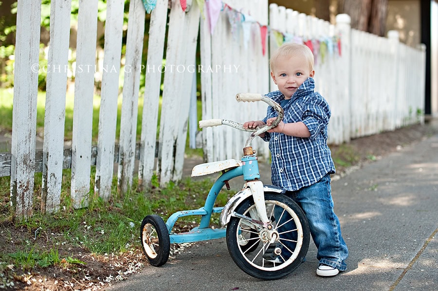 LITTLE BOY HOLDING ONTO A TRICYCLE