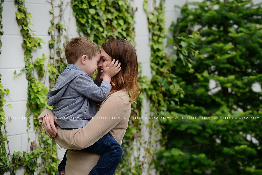MOM & SON IN FRONT OF VINE WALL SMILING