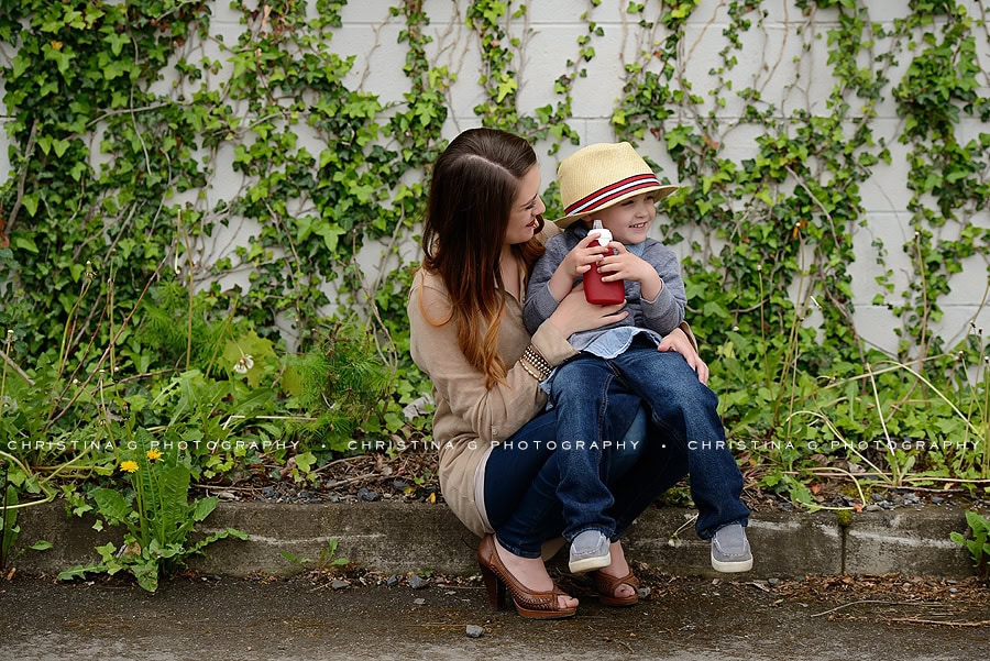 MOM & SON SITTING IN FRONT OF VINE WALL