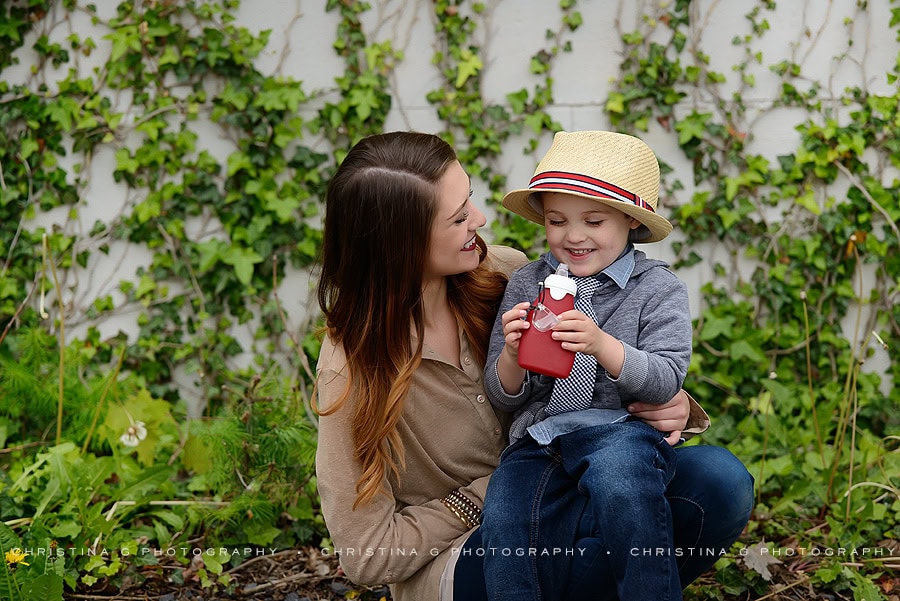 MOM & SON SITTING IN FRONT OF VINE WALL