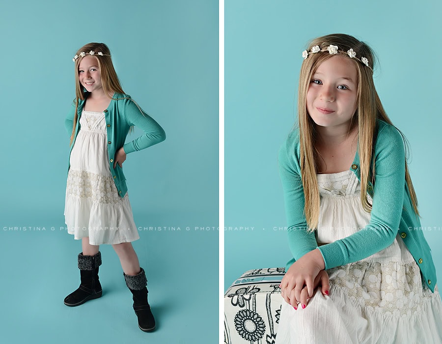 YOUNG GIRL WITH CREAM DRESS IN STUDIO WITH TURQUOISE BACKGROUND