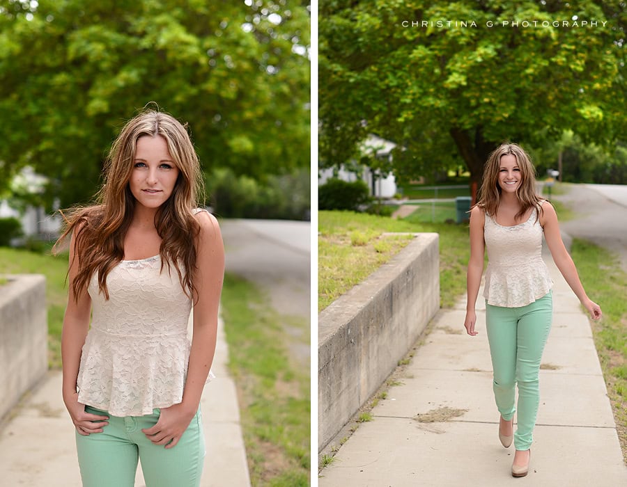 PRETTY TEEN GIRL WITH CREAM TANK TOP AND SOFT SMILE WALKING ON SIDEWALK
